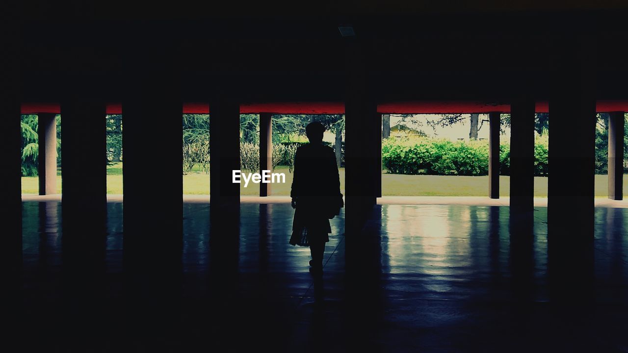 Silhouette woman standing in corridor