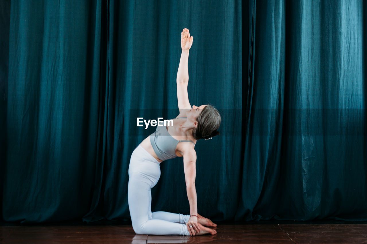 Side view of woman exercising at gym