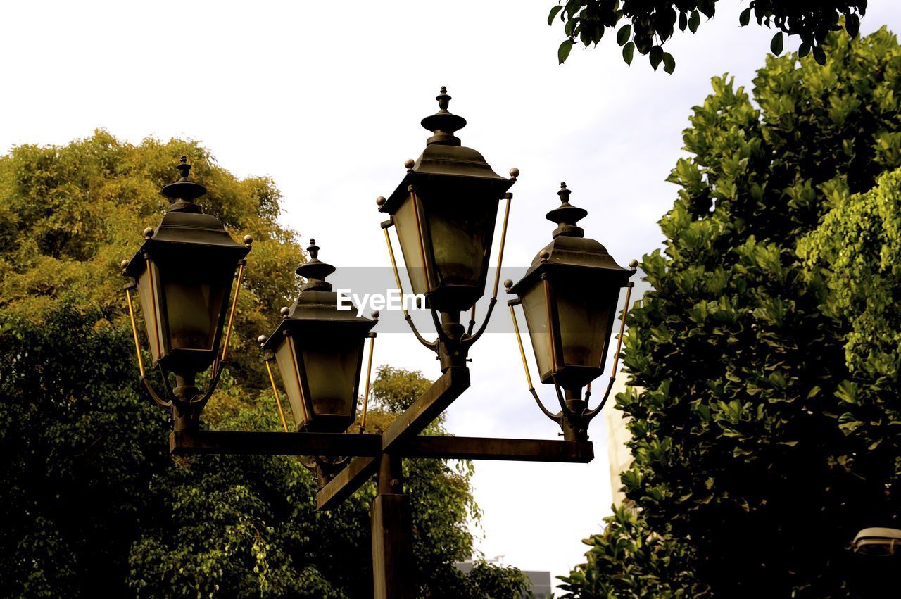 Low angle view of lamp posts against sky