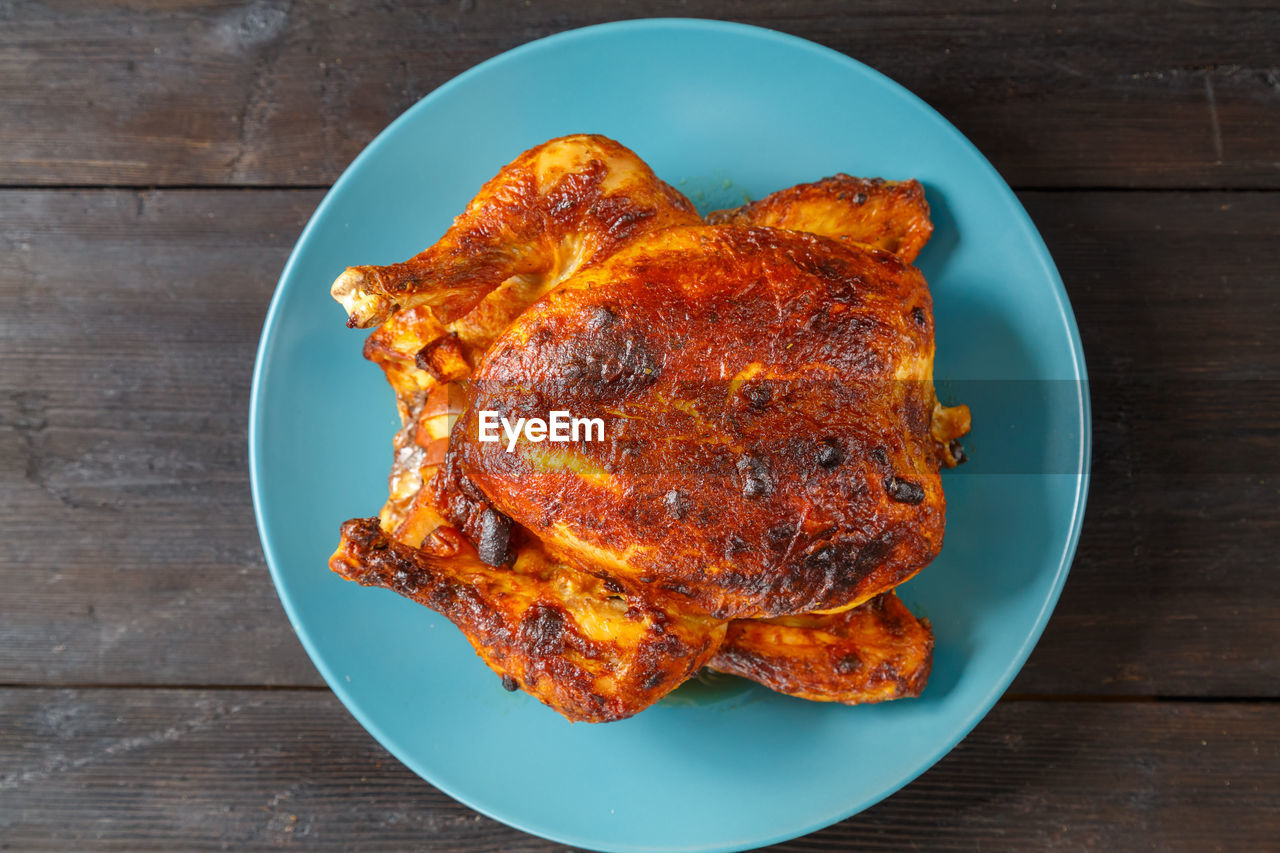 food and drink, food, fried food, wood, dish, meat, hendl, chicken meat, freshness, roasted, chicken, no people, directly above, plate, studio shot, produce, meal, indoors, wellbeing, tandoori chicken, healthy eating, high angle view, table, white meat, fast food, barbecue chicken, blue