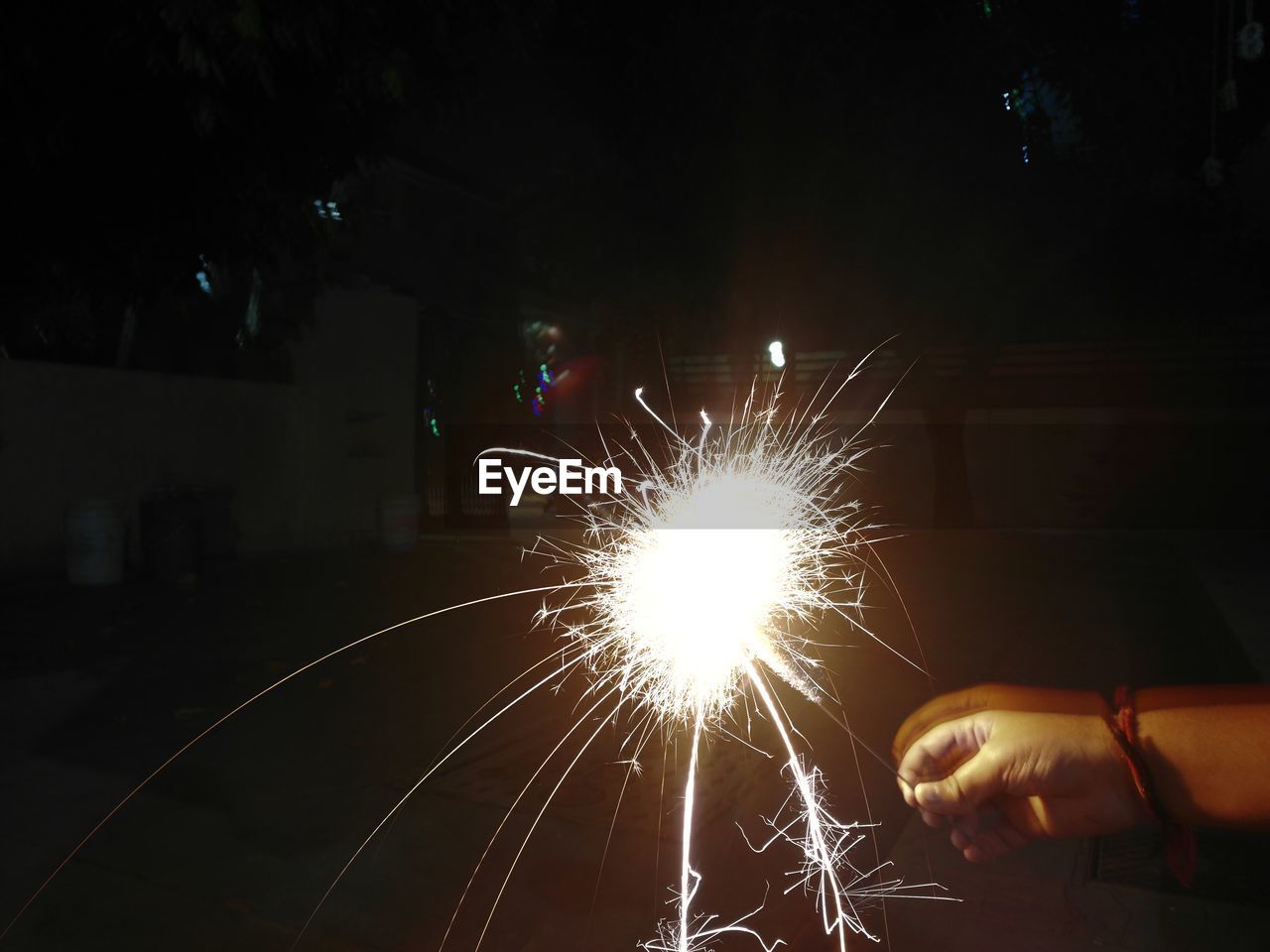 LOW ANGLE VIEW OF FIREWORKS EXPLODING AT NIGHT