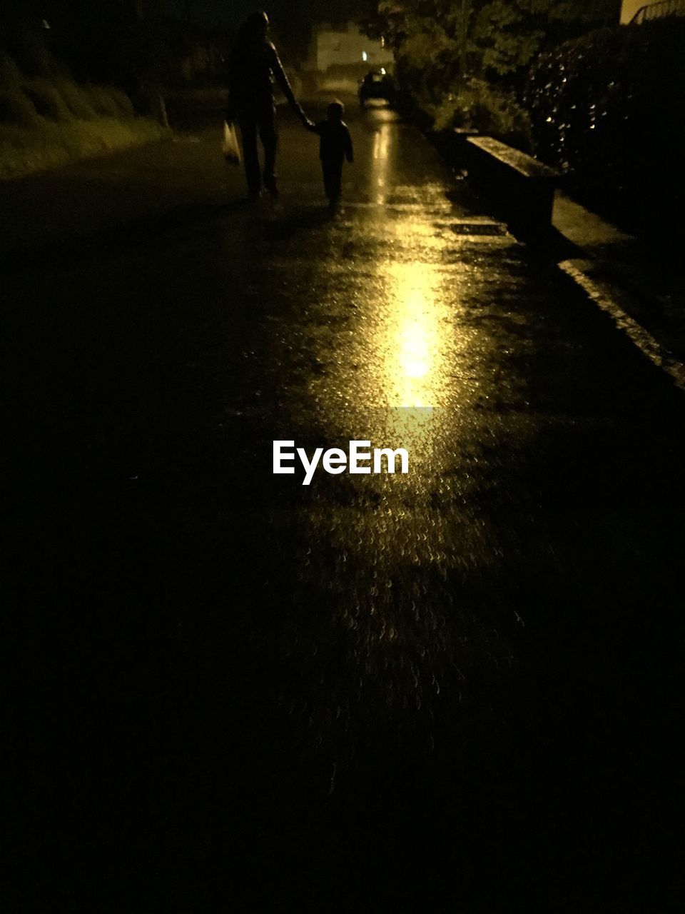 People on wet street at night