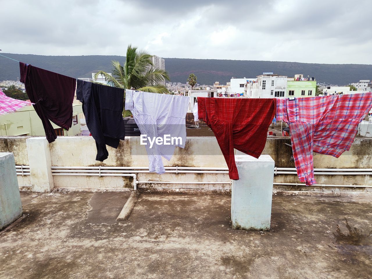 CLOTHES DRYING ON CLOTHESLINE AGAINST BUILT STRUCTURES
