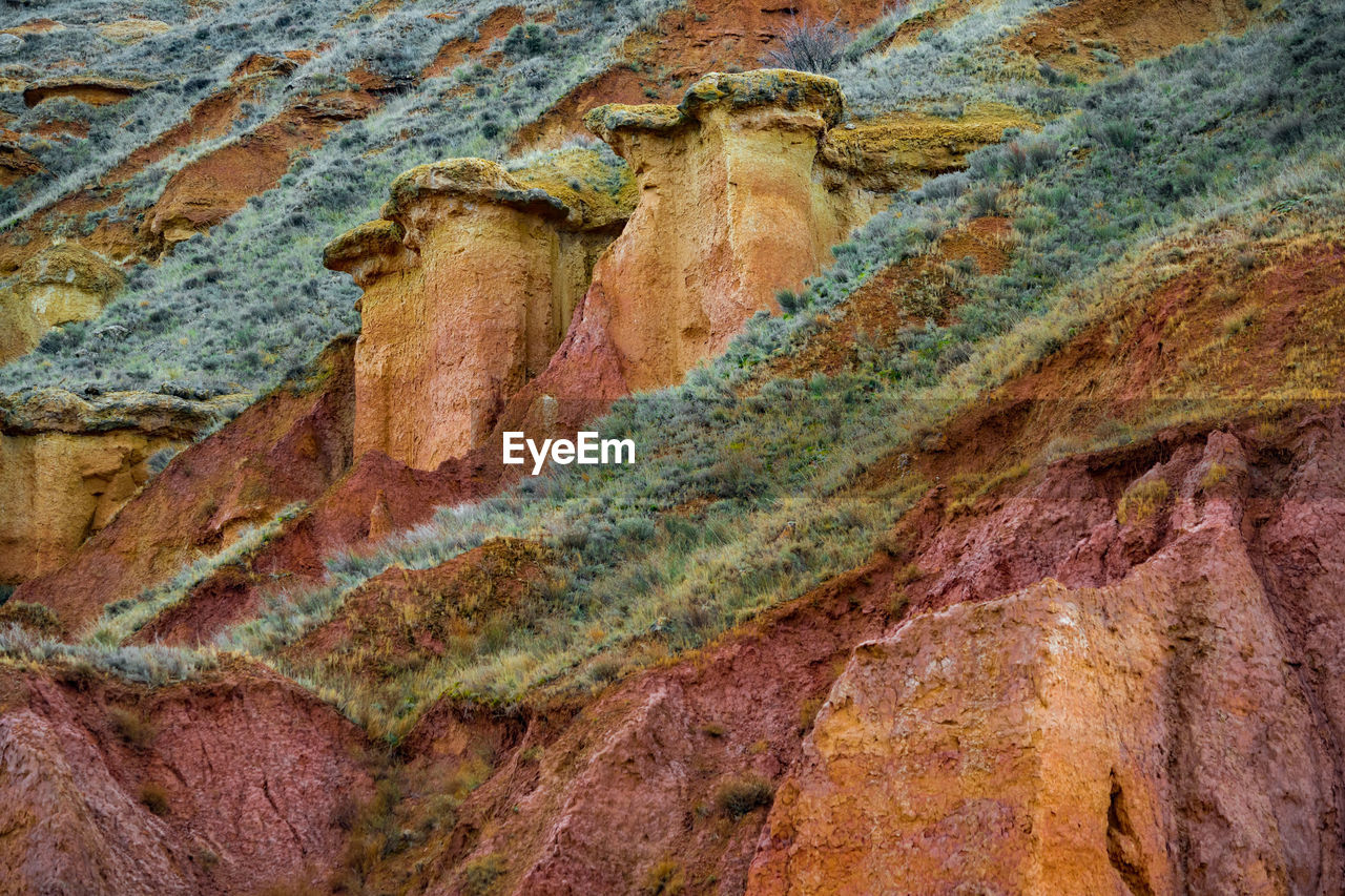 Full frame shot of  colourful rock formation with grass