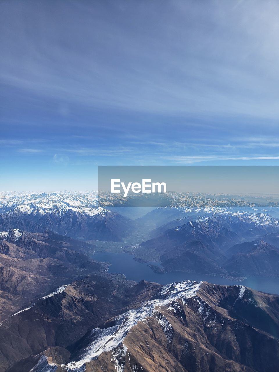 Aerial view of snowcapped mountains against sky