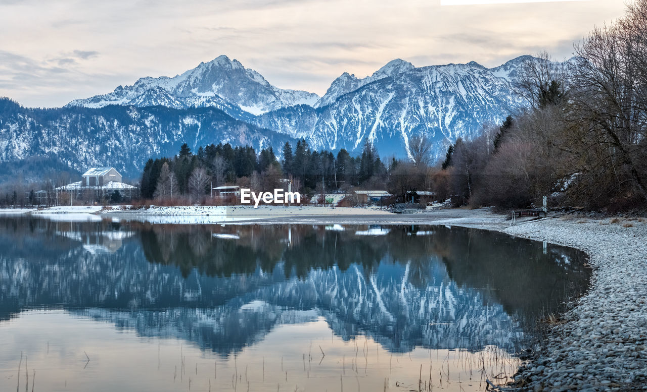 Scenic view of lake and snowcapped mountains against sky