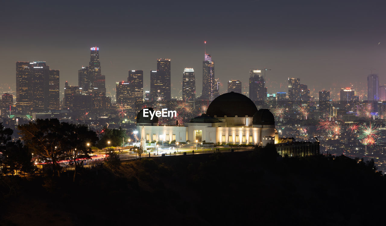 Fourth of july fireworks over griffith observatory with the los angeles skyline in the distance