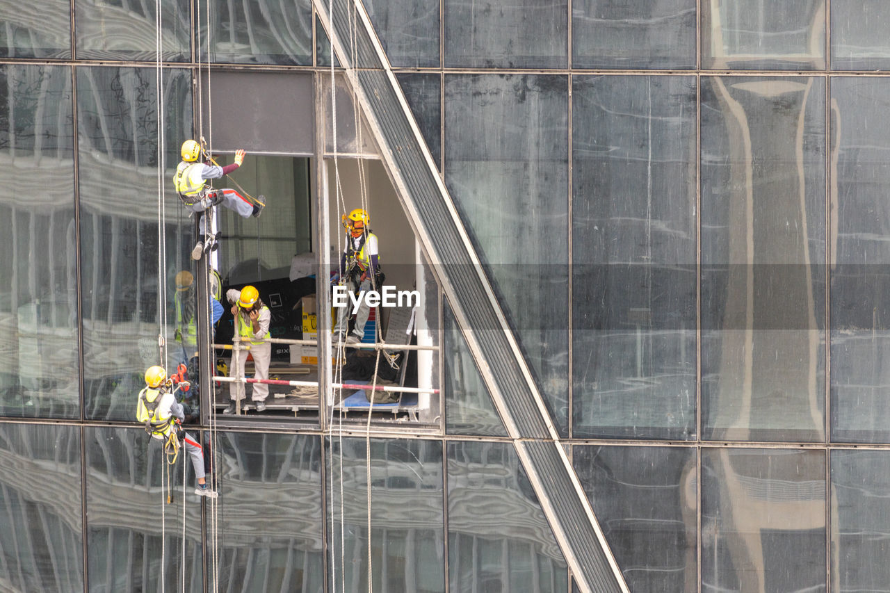 Window washers on building