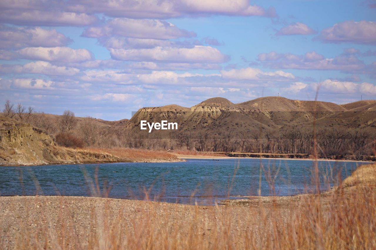 Scenic view of lake against cloudy sky