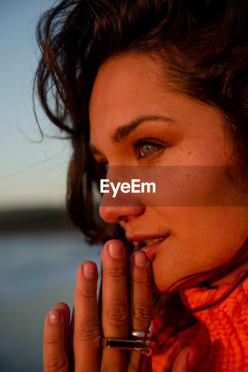 Peaceful woman takes in the view at sunset