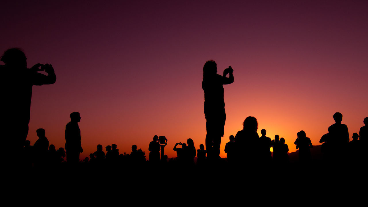 People taking photos during sunset