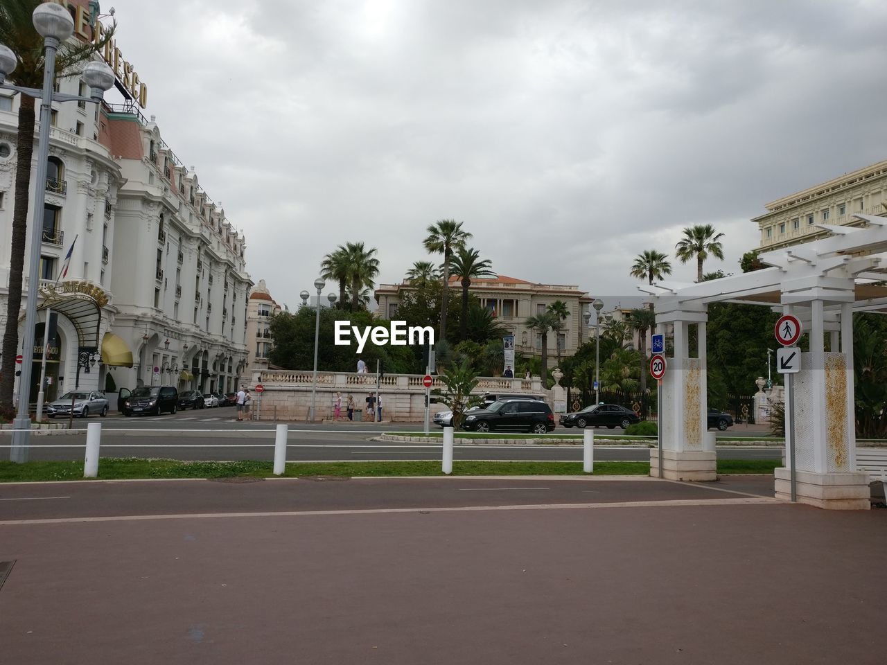 STREET BY BUILDINGS AGAINST SKY