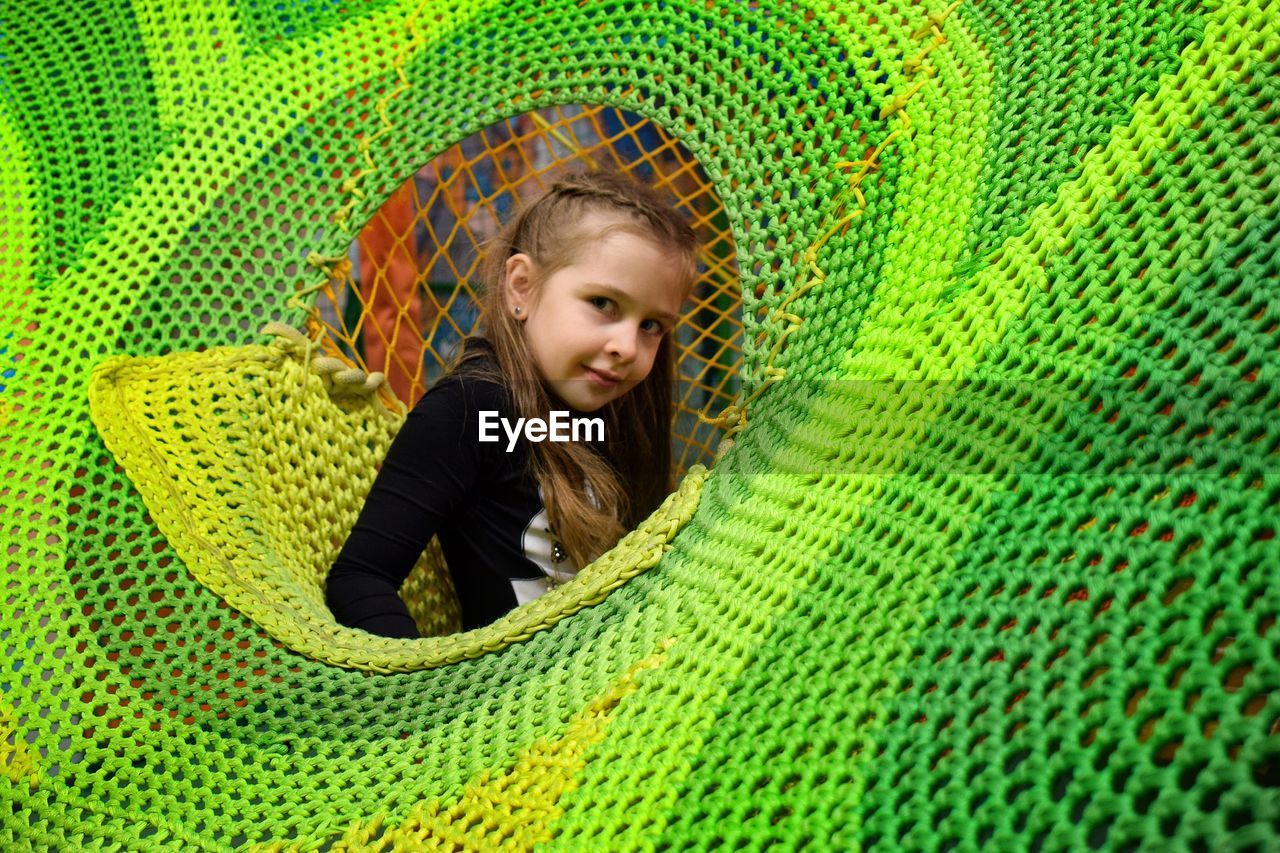 Portrait of smiling girl playing in jungle gym