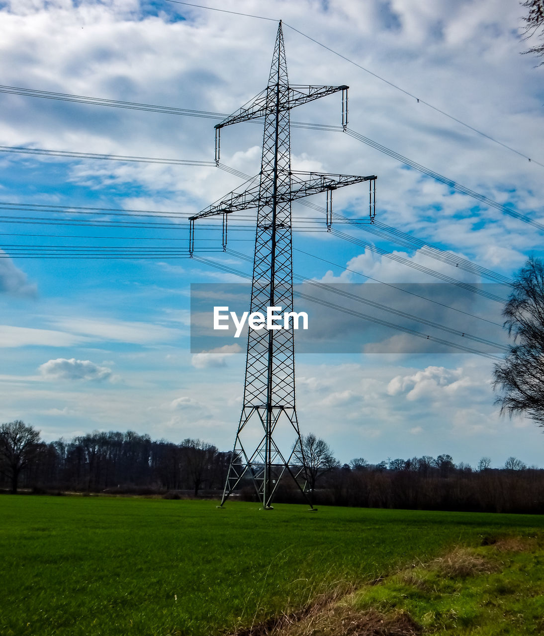 technology, electricity, sky, power generation, cloud, electricity pylon, cable, power supply, transmission tower, overhead power line, nature, plant, tower, power line, environment, landscape, no people, land, grass, field, wind, built structure, architecture, outdoors, rural scene, tree, agriculture, environmental conservation, day, scenics - nature, outdoor structure, renewable energy, electrical grid