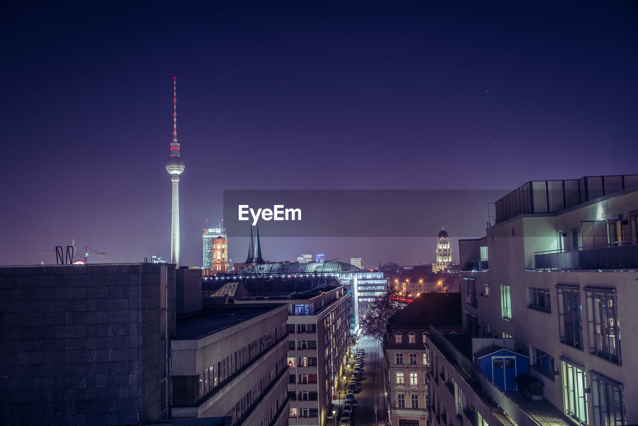 Fernsehturm in city against sky at night