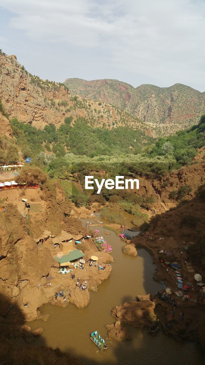 High angle view of river and mountains against sky