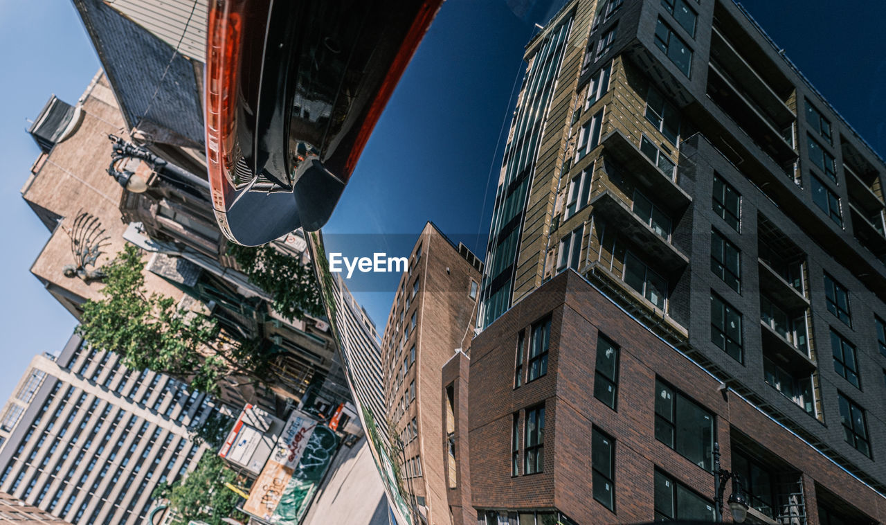 LOW ANGLE VIEW OF BUILDINGS AGAINST SKY IN CITY