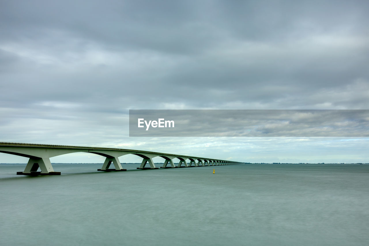 Bridge over sea against sky