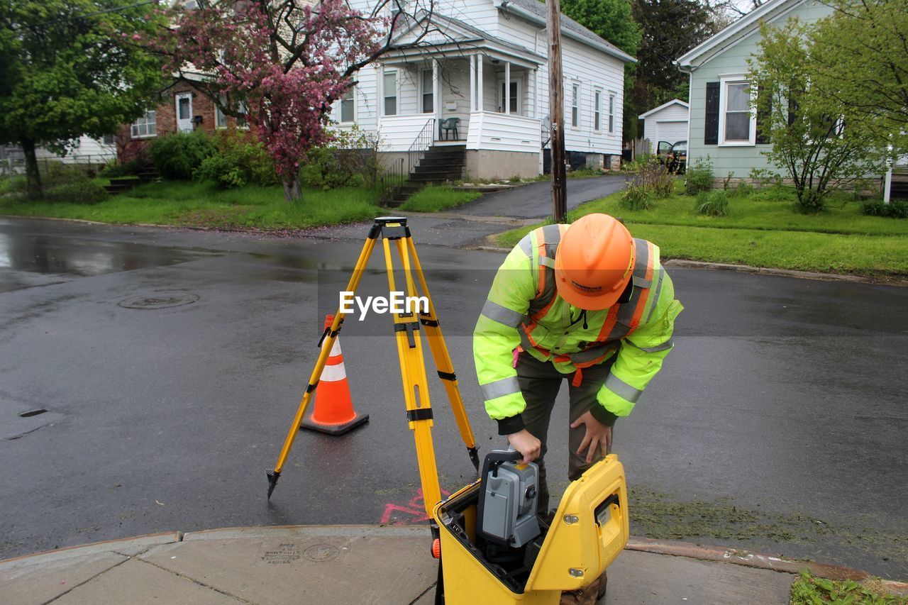 Man working on road by building