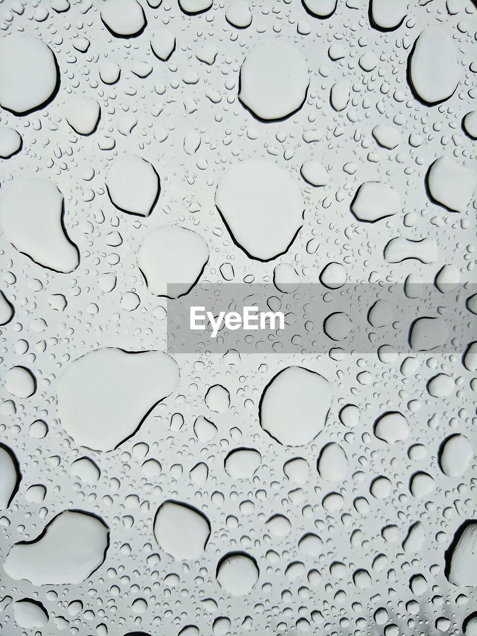 FULL FRAME SHOT OF WATER DROPS ON GLASS