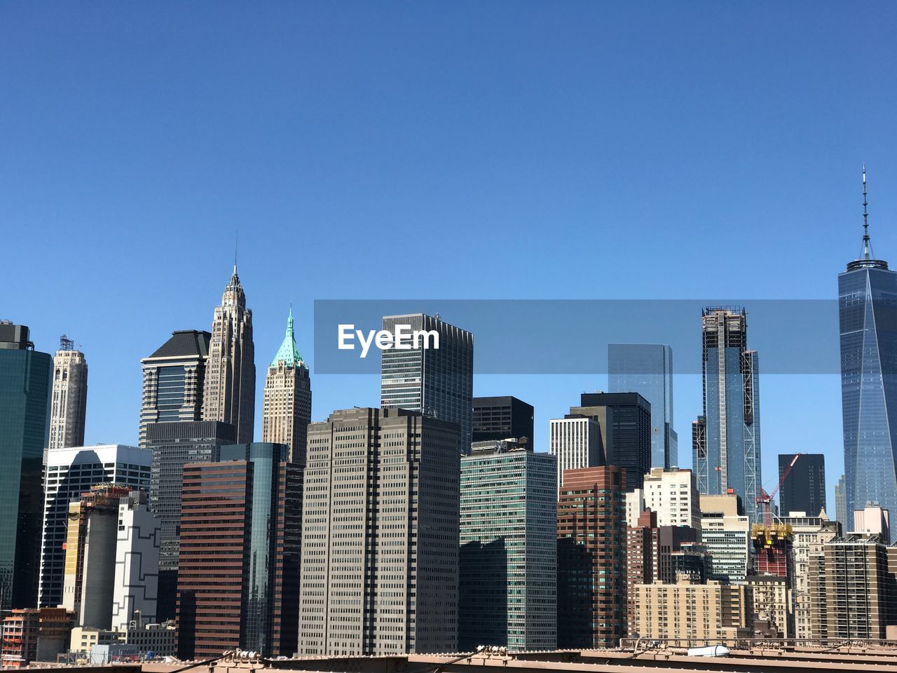 Buildings in city against clear sky