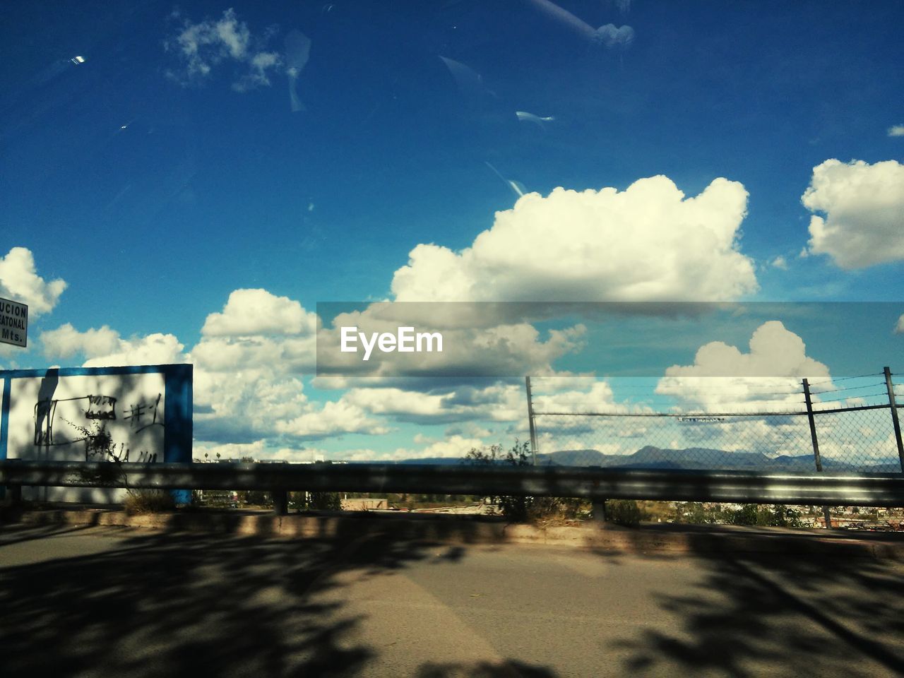 Street against cloudy blue sky