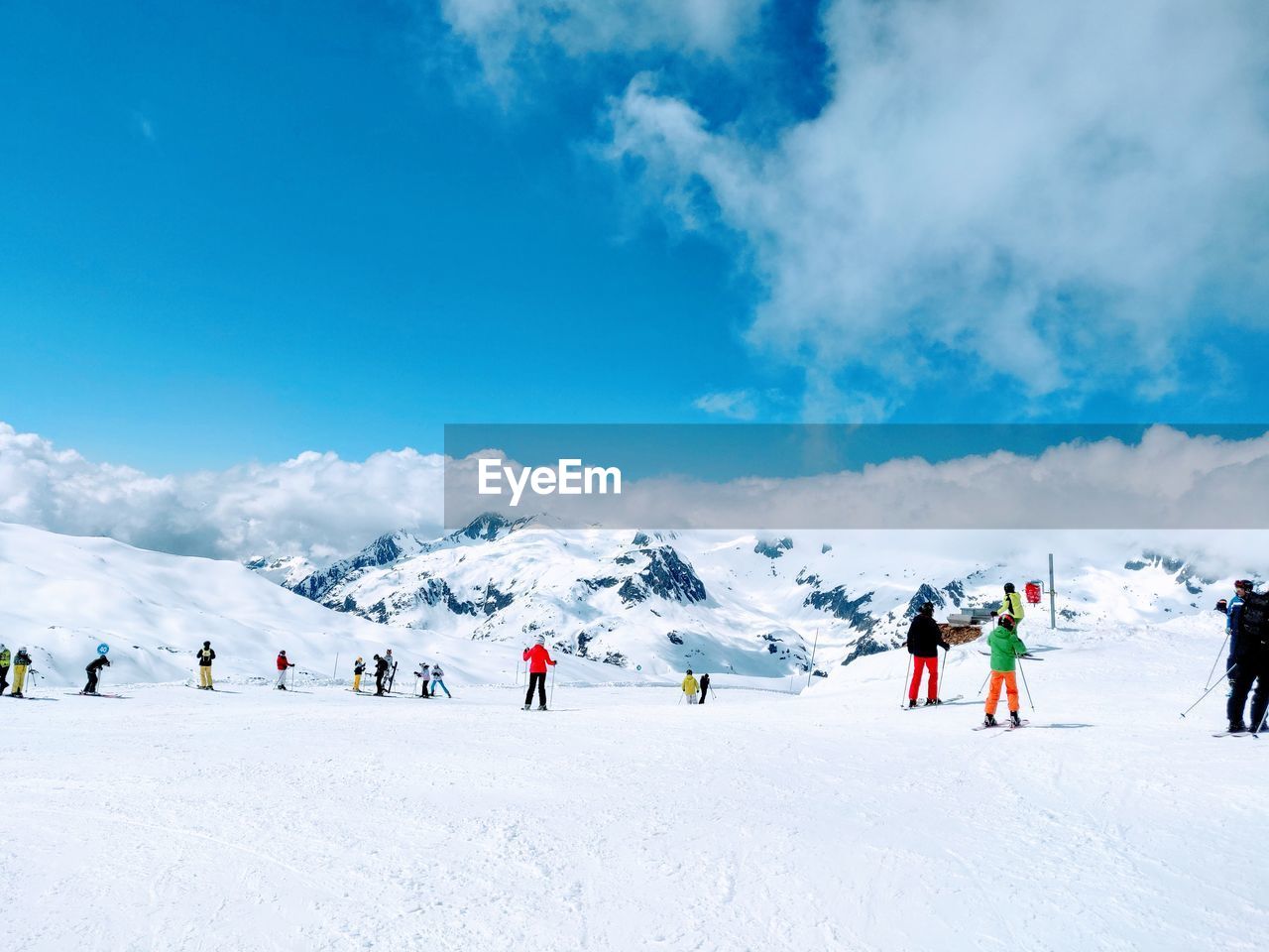 GROUP OF PEOPLE ON SNOWCAPPED MOUNTAIN