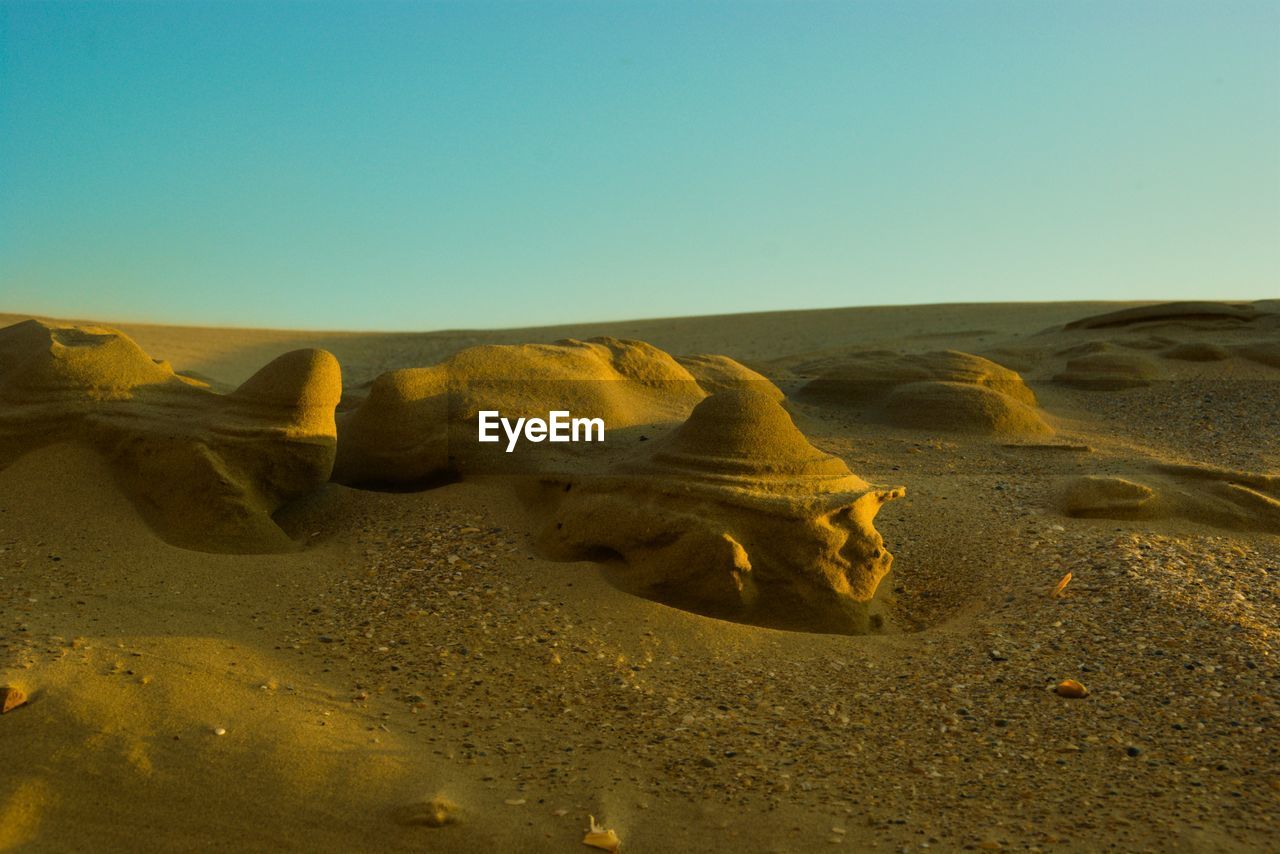 Scenic view of desert against clear sky