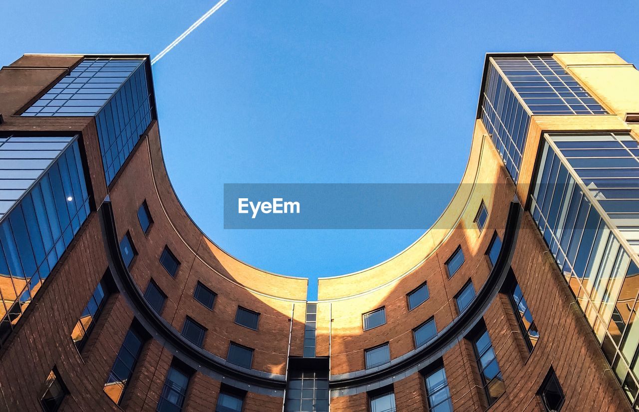 LOW ANGLE VIEW OF BUILDING AGAINST BLUE SKY