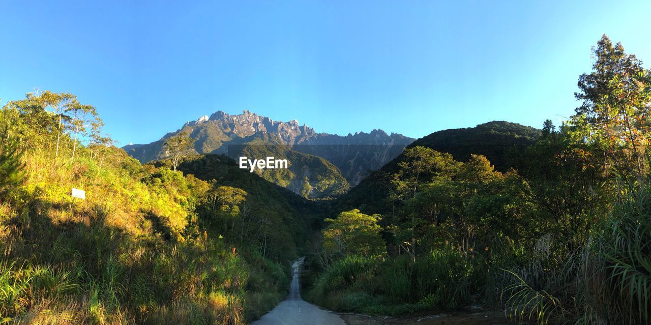 Scenic view of mountains against clear blue sky