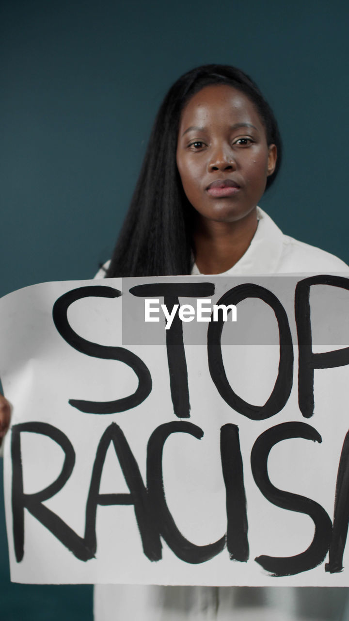 Portrait of woman holding banner