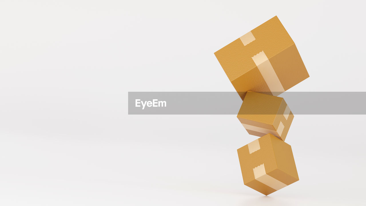 studio shot, copy space, yellow, art, indoors, white background, no people, paper, orange, box, cut out, business, lighting, cardboard