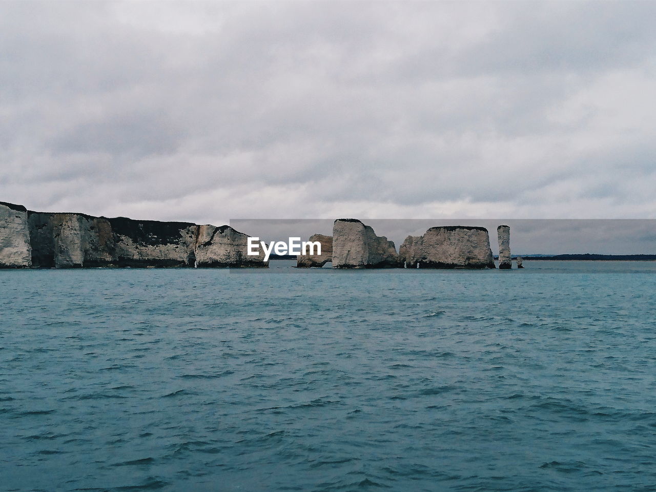 Scenic view of rocks in sea against sky