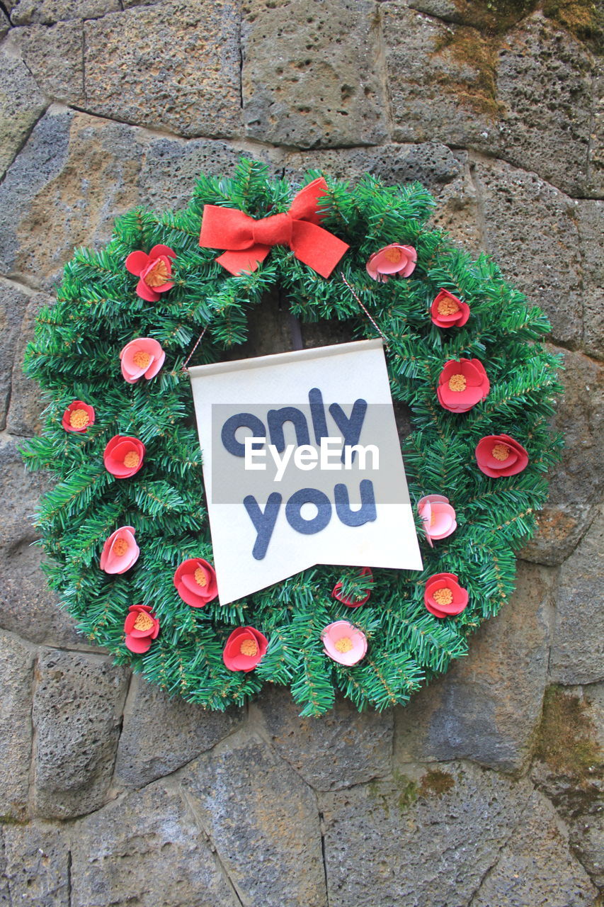 Close-up of wreath on stone wall