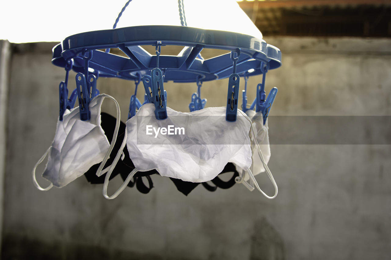 Drying mask hanging under the sun after use for disinfecting. cotton cloth mask hanging outdoor.