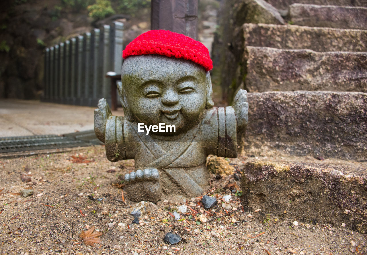 Close-up of statue on sand