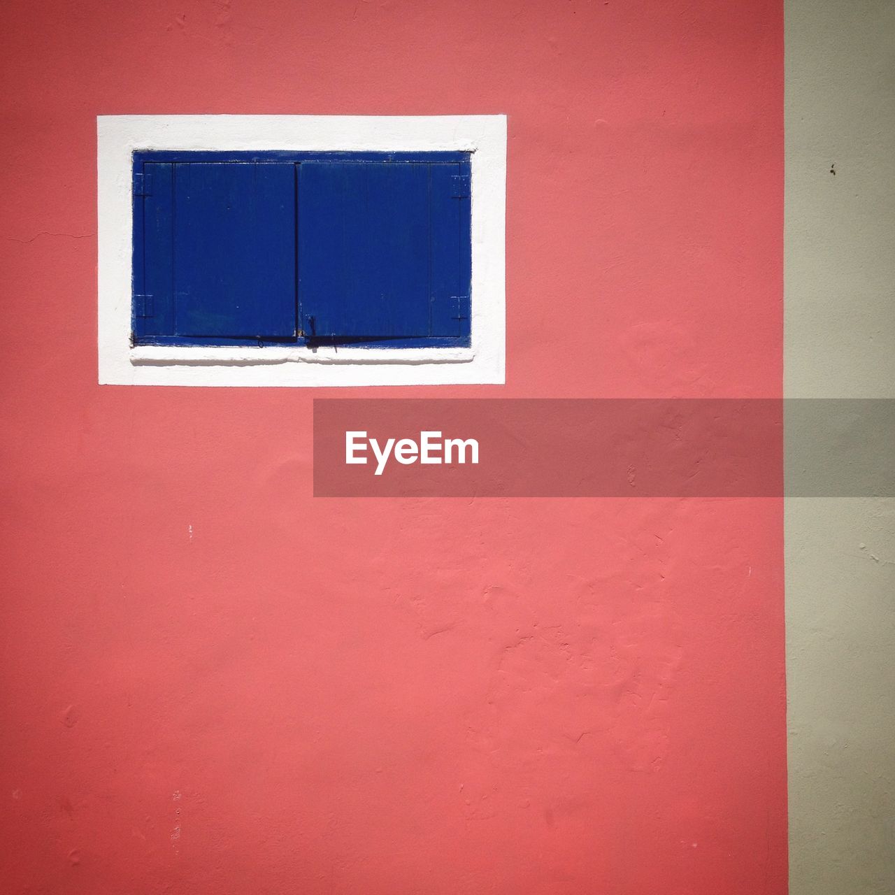 Closed blue window on house wall