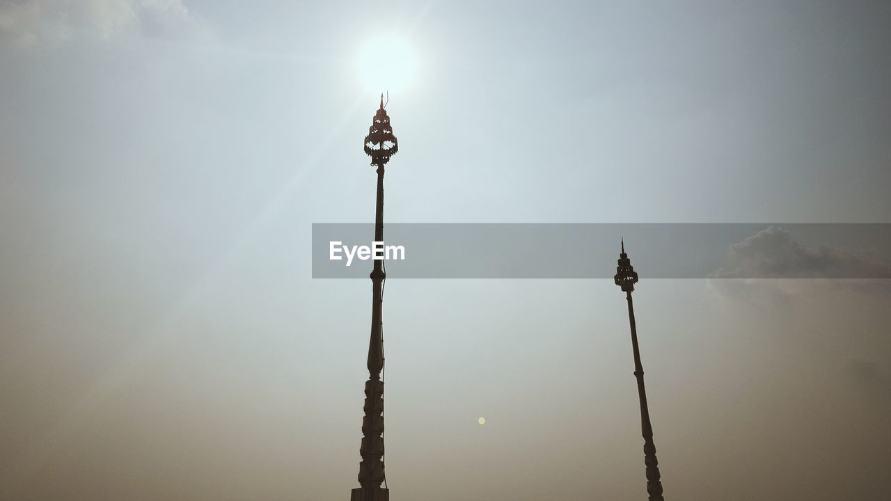 Low angle view of street lights against sky