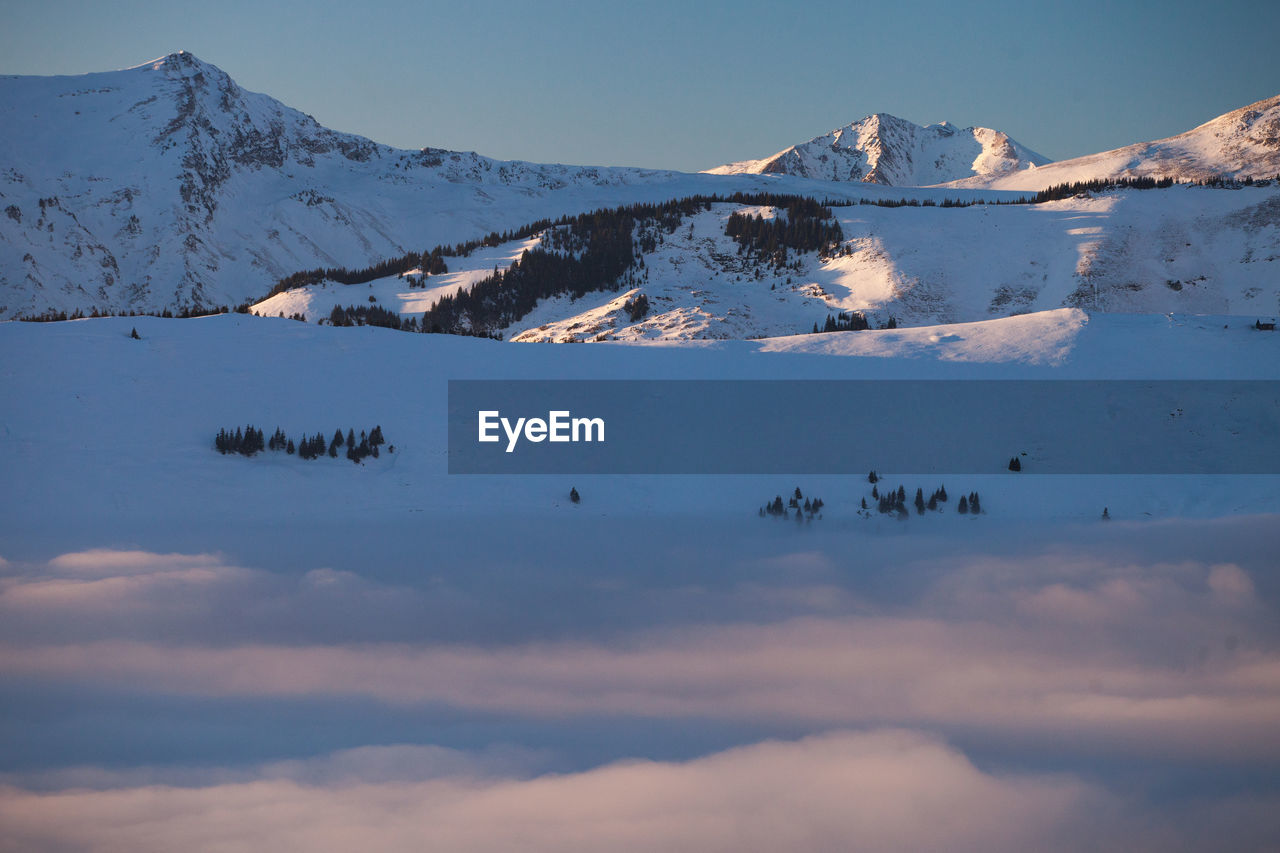 Scenic view of snowcapped mountains against sky