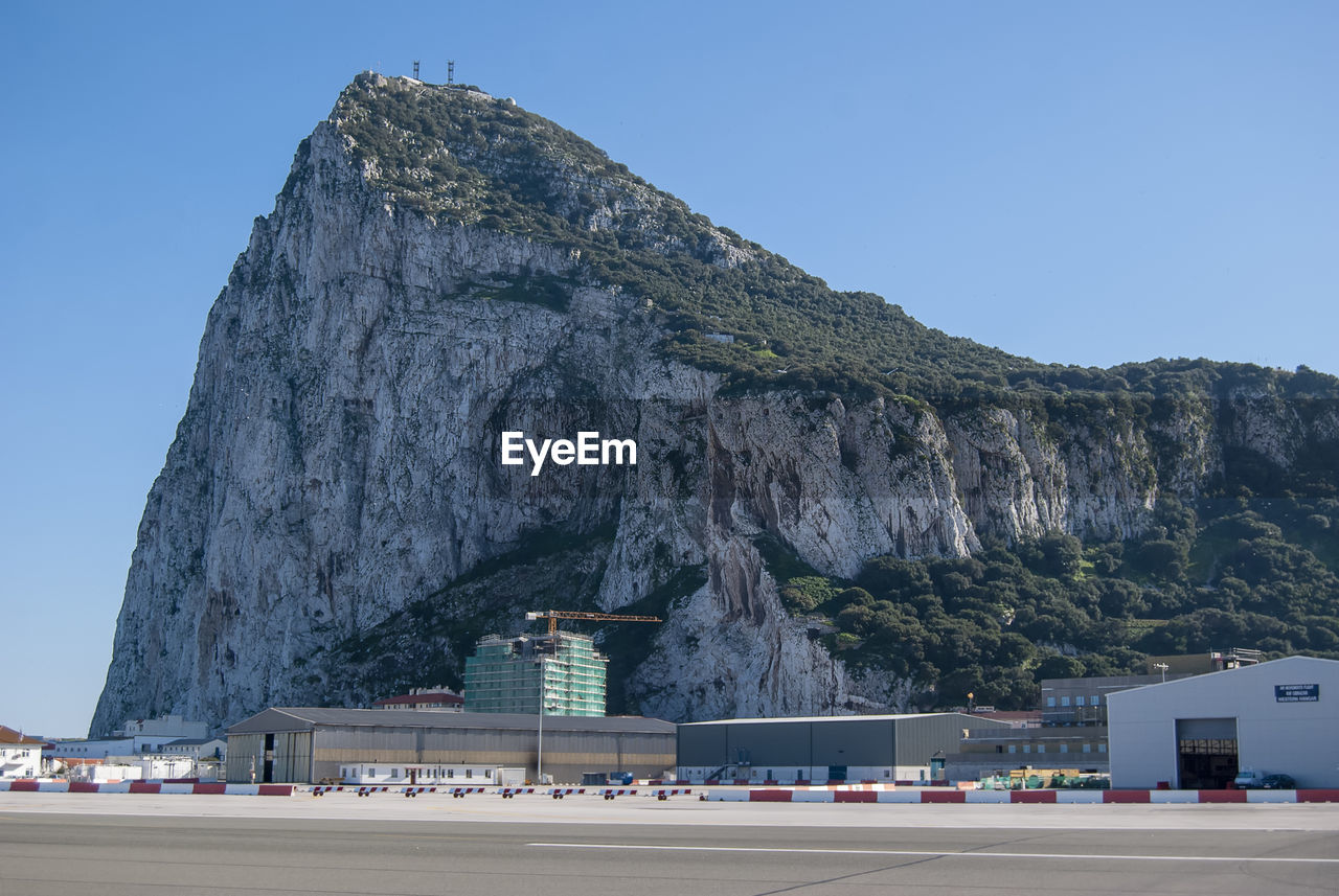 BUILT STRUCTURE BY SEA AGAINST CLEAR SKY