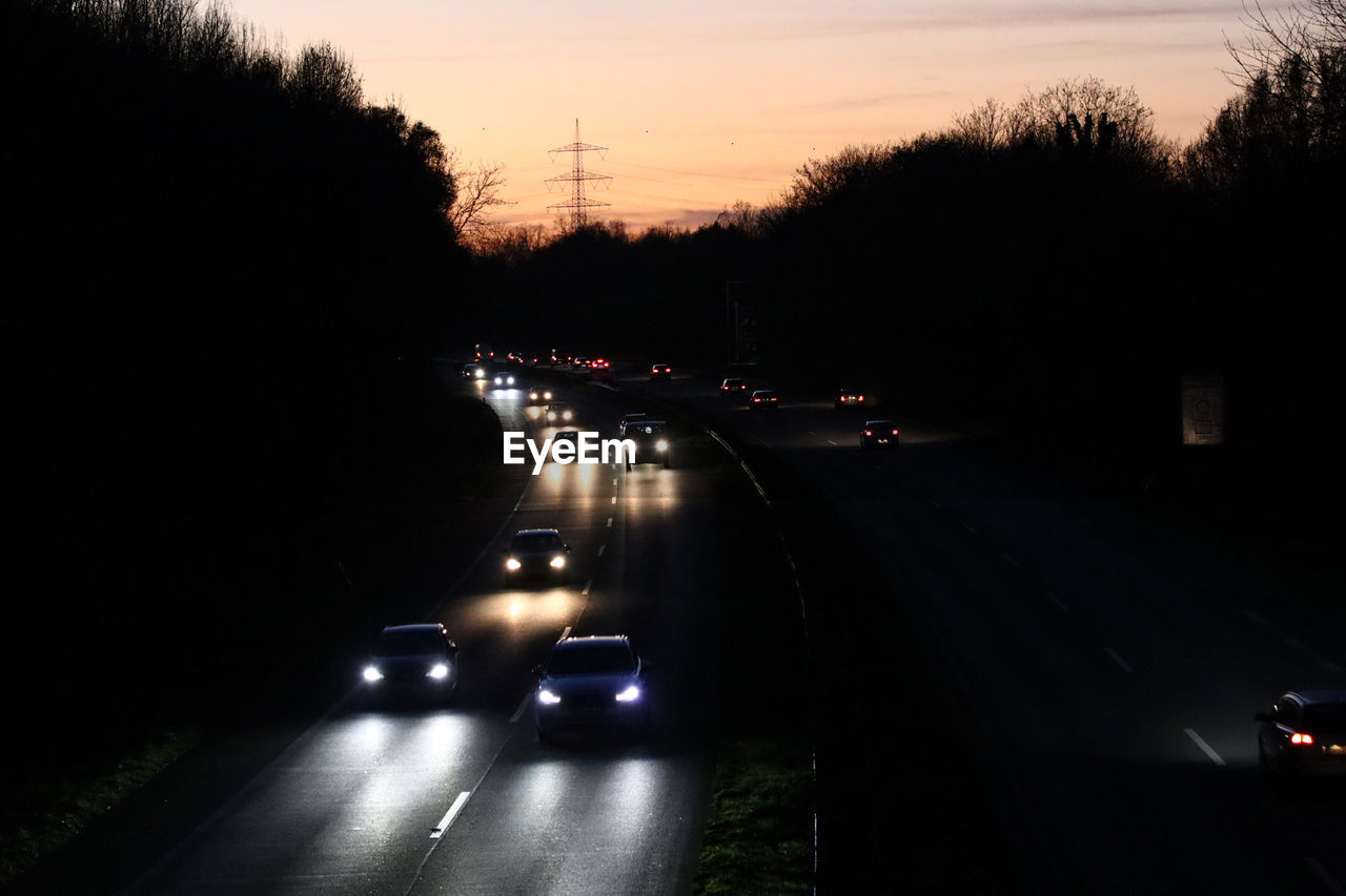 CARS ON ROAD AT SUNSET