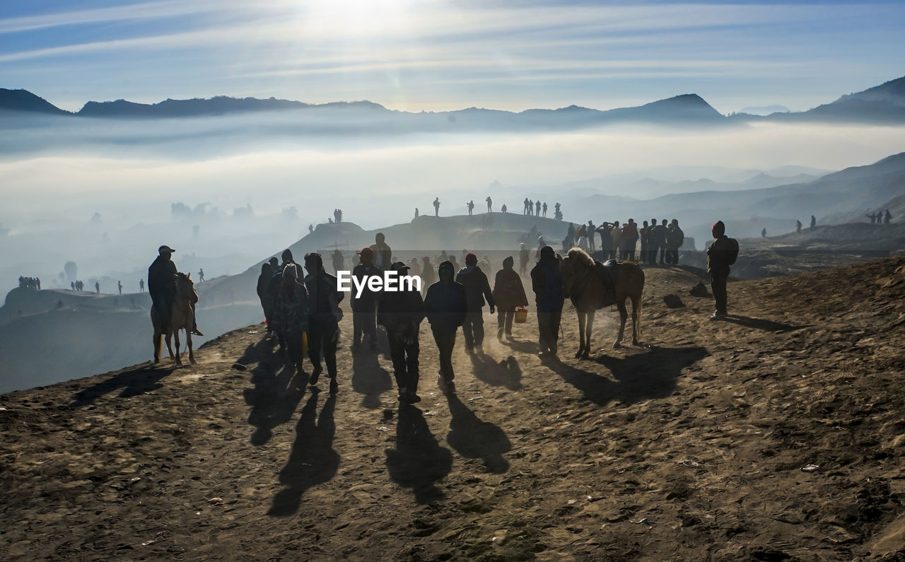 GROUP OF PEOPLE WALKING ON LAND