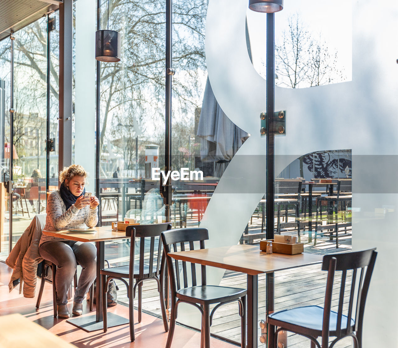 WOMAN SITTING ON TABLE AT RESTAURANT