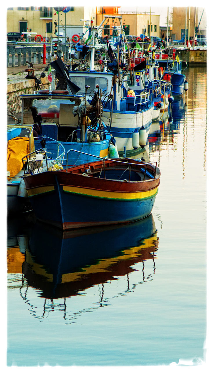 Boats moored at harbor