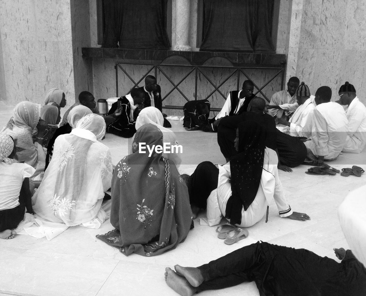 High angle view of people discussing while sitting at mosque