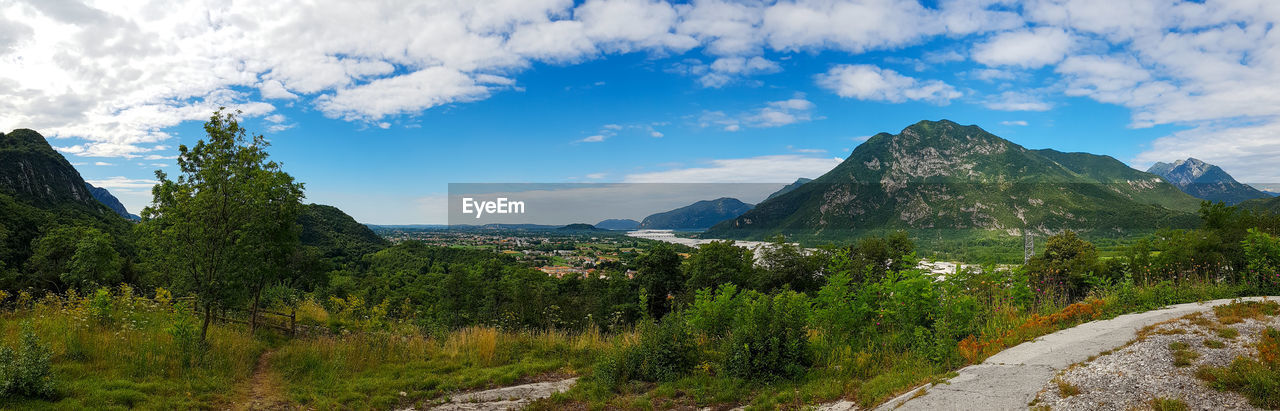 SCENIC VIEW OF TREES AND MOUNTAINS AGAINST SKY