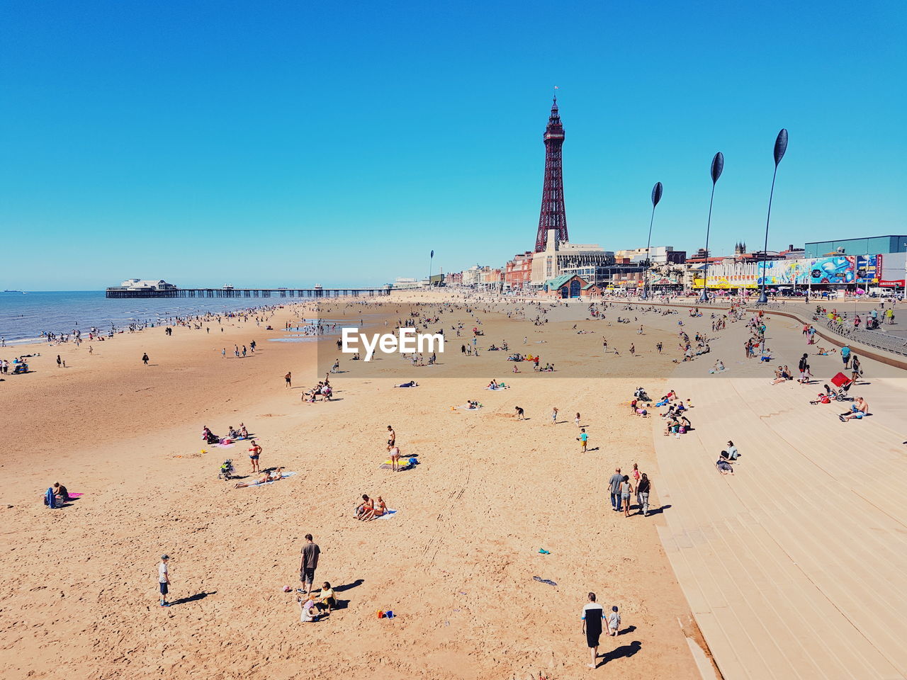 A group of people on the beach in blackpool. 