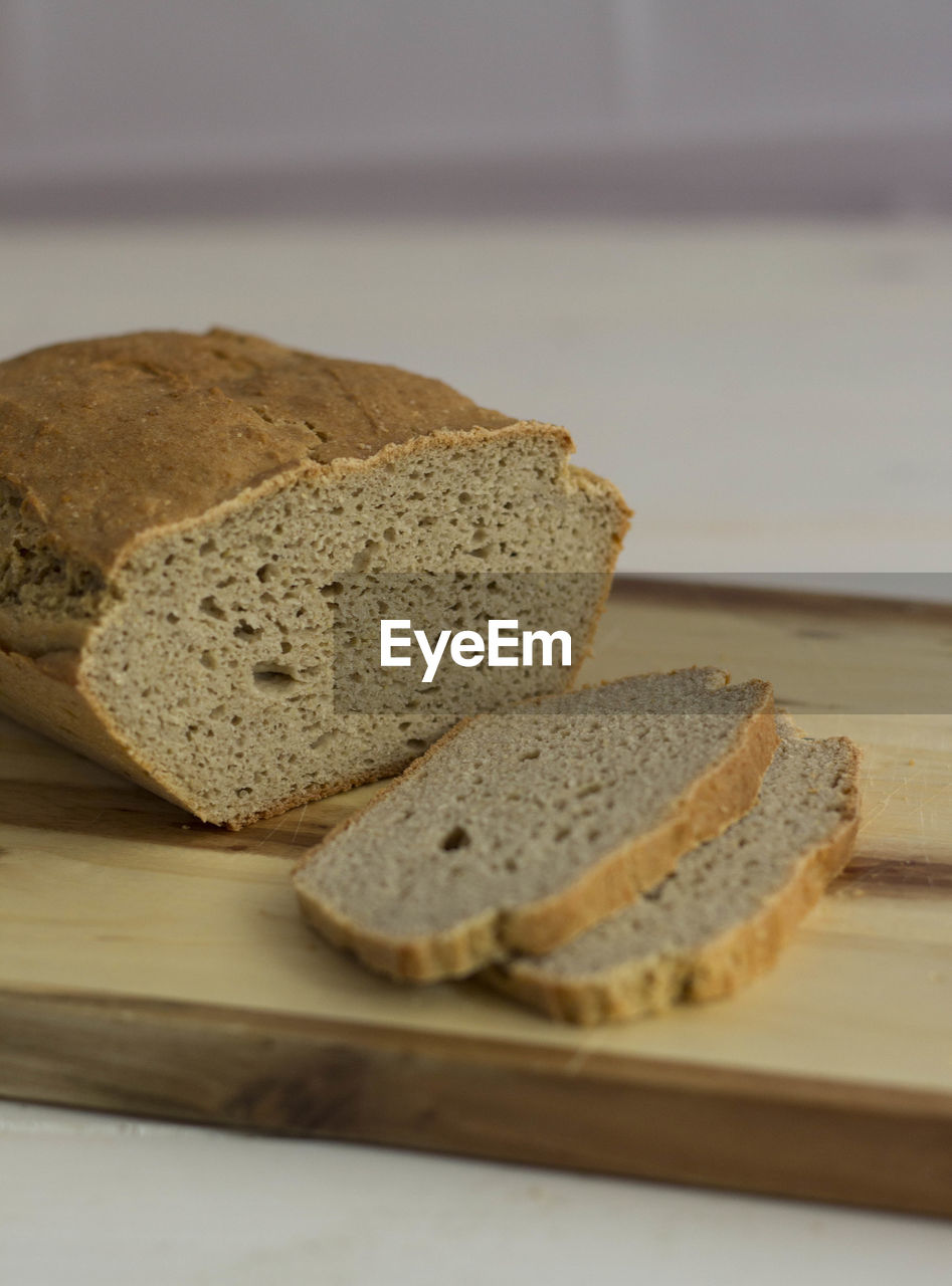 View of loaf of brown bread with two slices