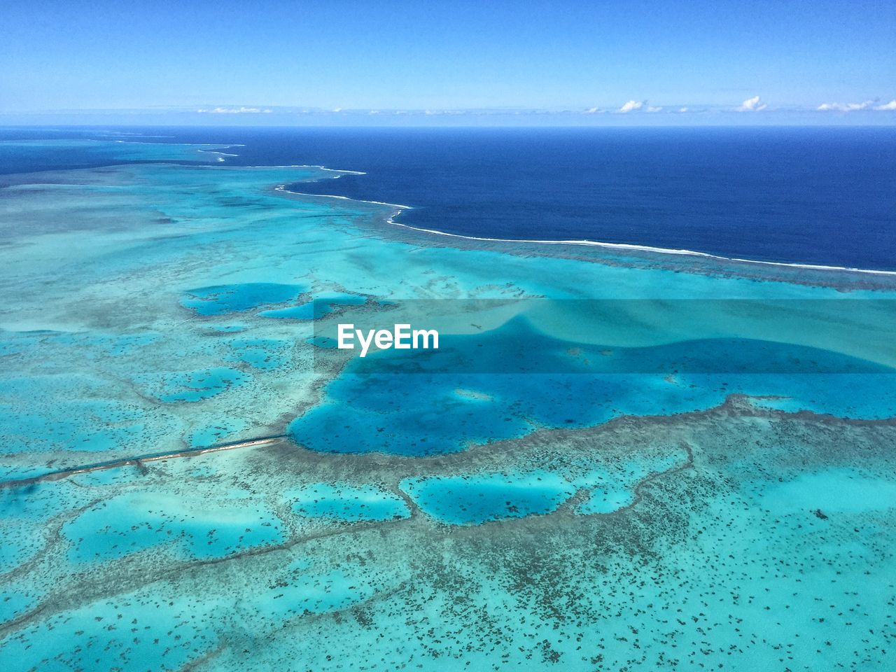 Aerial view of sea against blue sky