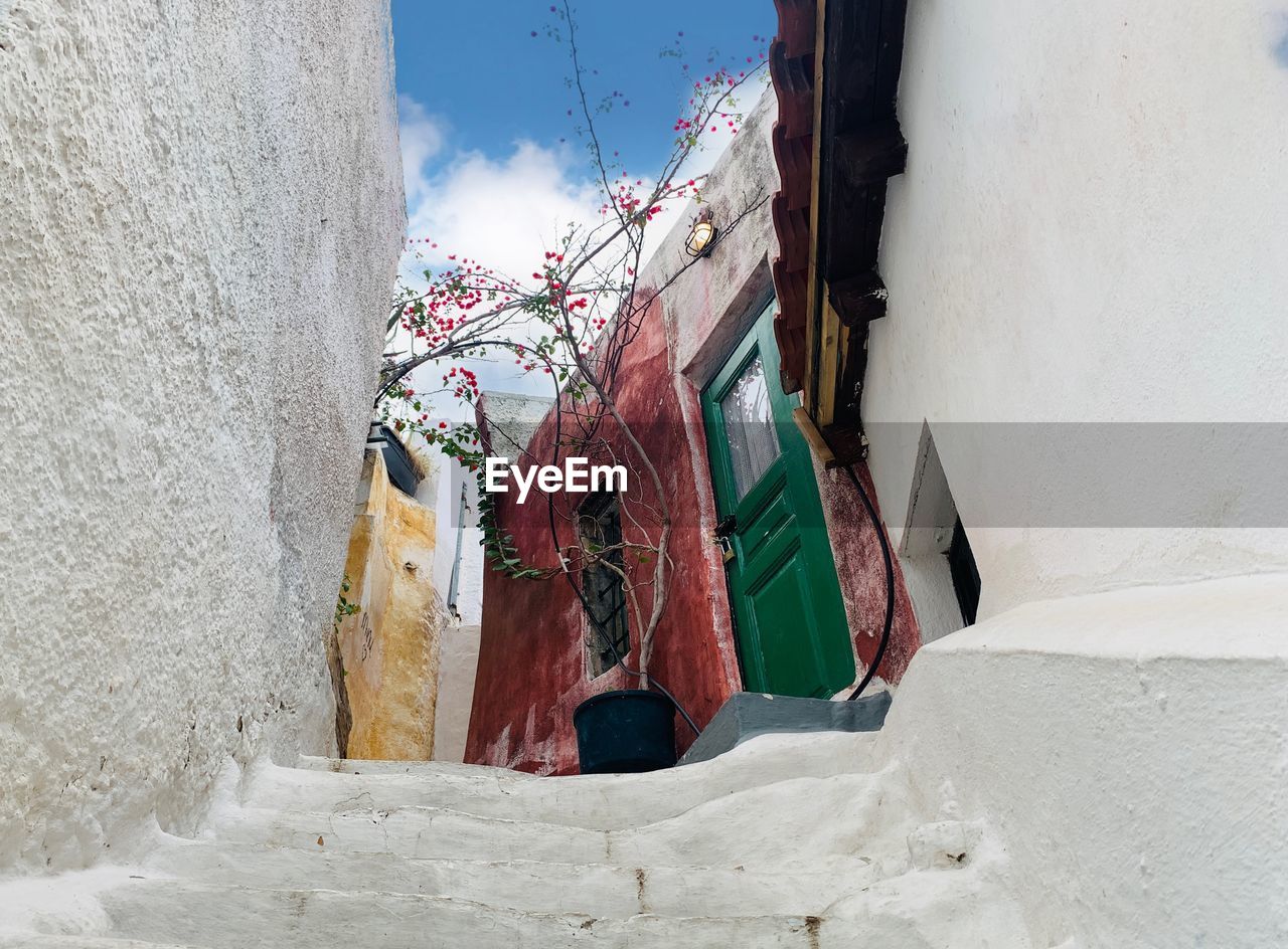 architecture, building exterior, built structure, wall, white, red, blue, wall - building feature, hanging, building, clothing, day, clothesline, no people, drying, laundry, nature, temple, winter, outdoors, spring, textile, road, street, window, low angle view, sky, city, residential district, sunlight, house